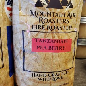 Mountain Air Roasters Fire Roasted coffee bag with a nautical compass on it, with a Tanzanian Pea Berry sticker on the bag