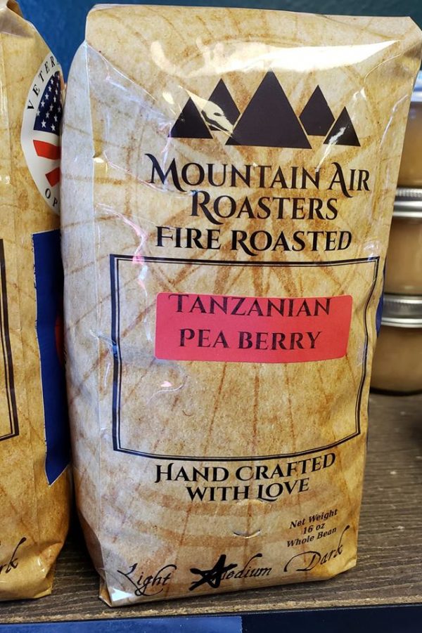 Mountain Air Roasters Fire Roasted coffee bag with a nautical compass on it, with a Tanzanian Pea Berry sticker on the bag