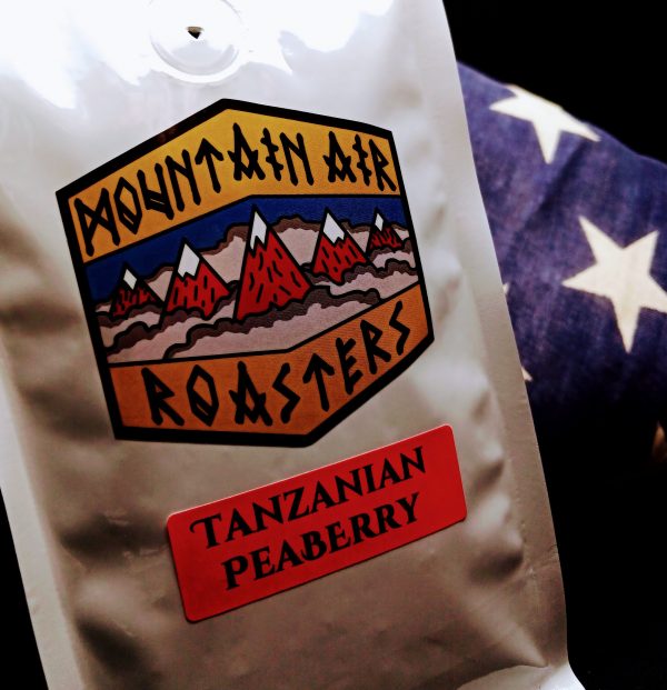 Tanzanian Coffee Air Roasted coffee bag with a nautical compass on it, with a Tanzanian Pea Berry sticker on the bag